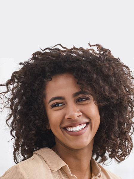 Young woman smiling after vagina laser rejuvenation in Greenwich, CT
