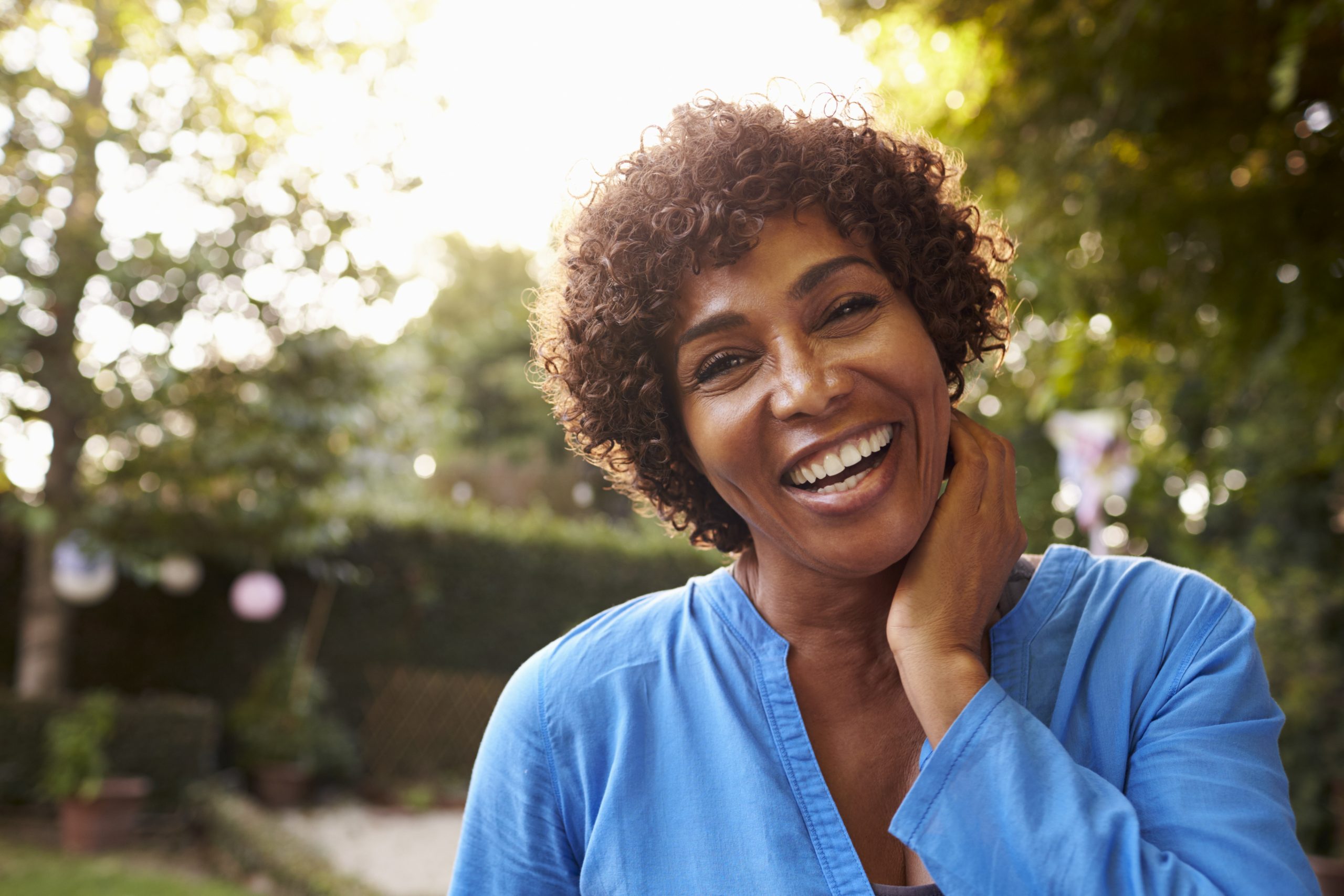 Woman smiling with man after labiaplasty surgery in Brooklyn, NY