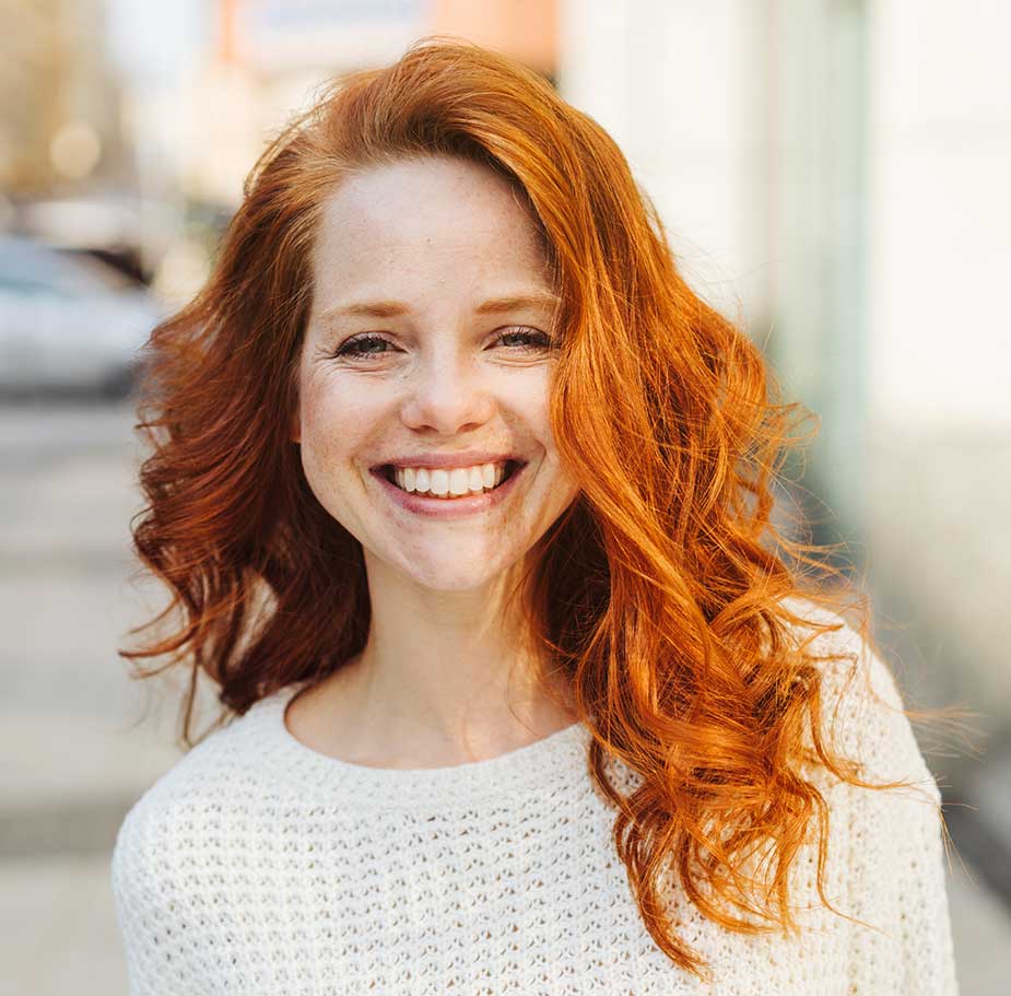 Red haired middle aged woman smiling after vaginal reconstruction surgery in Manhattan
